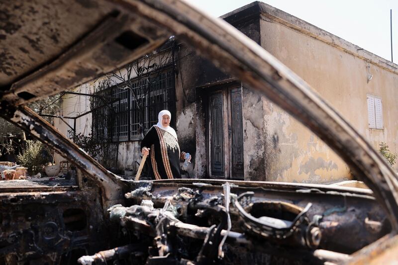 A Palestinian woman she stands outside her house, which was set on fire by Israeli settlers in Turmus Aya near the occupied West Bank city of Ramallah. Photograph: Ahmad Gharabli/AFP