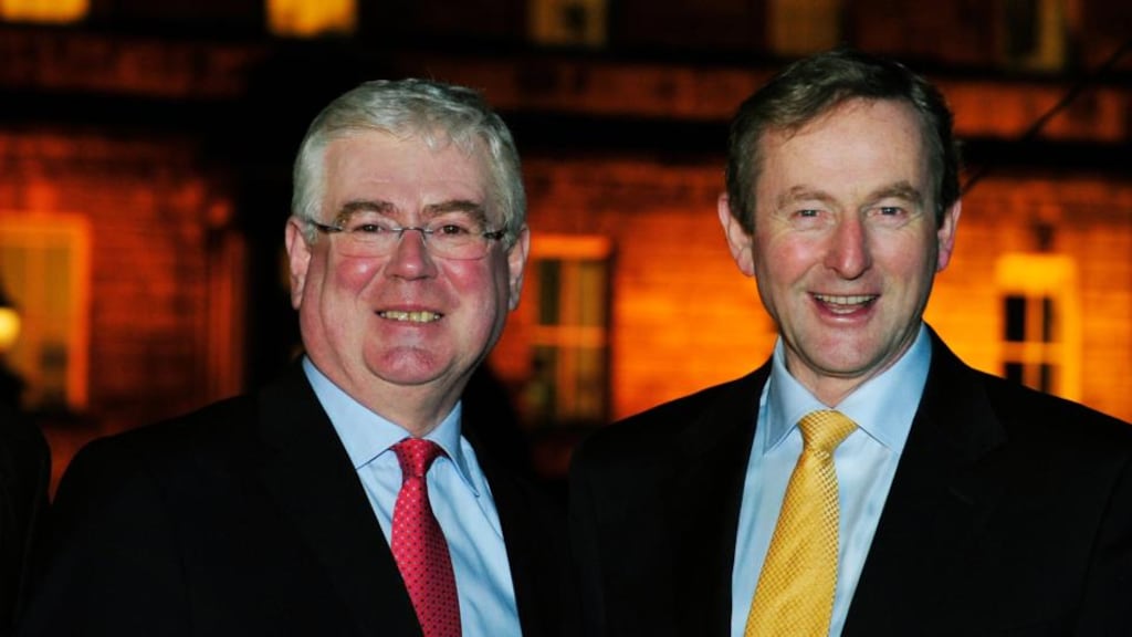 Tánaiste Eamon Gilmore and Taoiseach Enda Kenny after the Christmas tree lights were turned on at Leinster House yesterday. Photograph: Aidan Crawley
