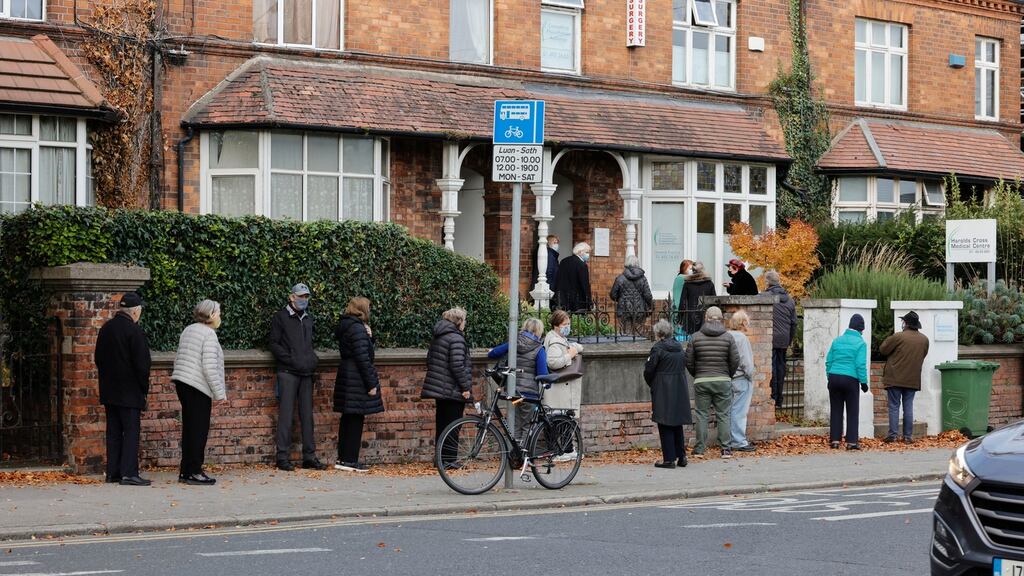 People queue for the booster vaccine at Harold’s Cross Medical Centre: Perspective: the booster is a triumph. Case numbers are falling in those lucky groups. Photograph: Alan Betson