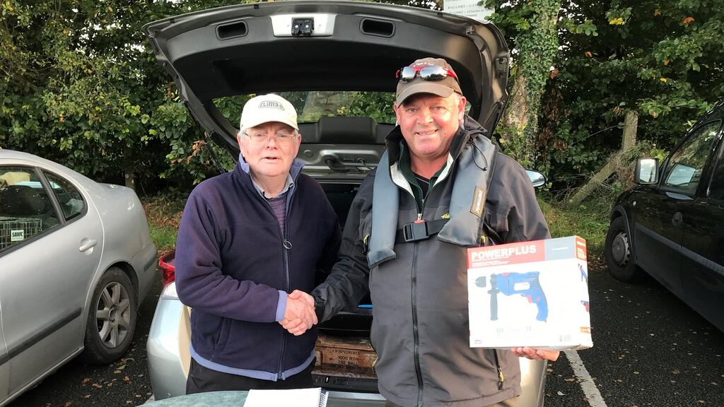 Gerry Heaslip (right) receiving his first prize from club secretary Stan Keon, following the fundraising competition on Lough Owel, last Sunday