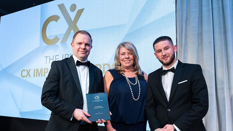 Adam Kane, community lead, BusinessRiver, presents the CX impact in financial services award to Pat McDermott and Osna O'Connor, Bank of Ireland.