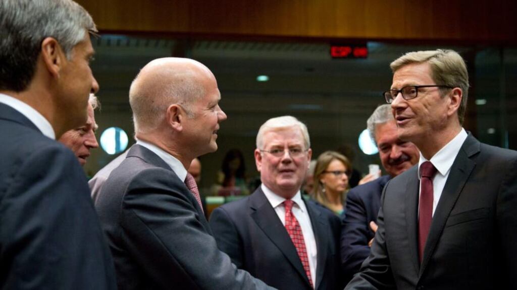 Tánaiste Eamon Gilmore looks on as Britain’s foreign minister William Hague greets his German counterpart Guido Westerwelle at an emergency meeting of EU foreign ministers in Brussels on August 21st. Photograph: Virginia Mayo/AP
