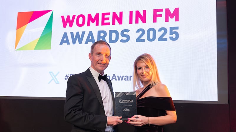 Trevor Smyth, awards judge, presents the excellence in senior leadership award to Gill McDonald, ISS Ireland