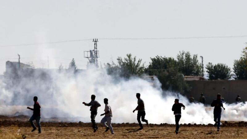 Turkish Gendarmerie use tear gas to disperse Kurdish protesters during a demonstration against Islamic State at the Syria-Turkey border near Sanliurfa today. Photograph: Sedat Suna/EPA
