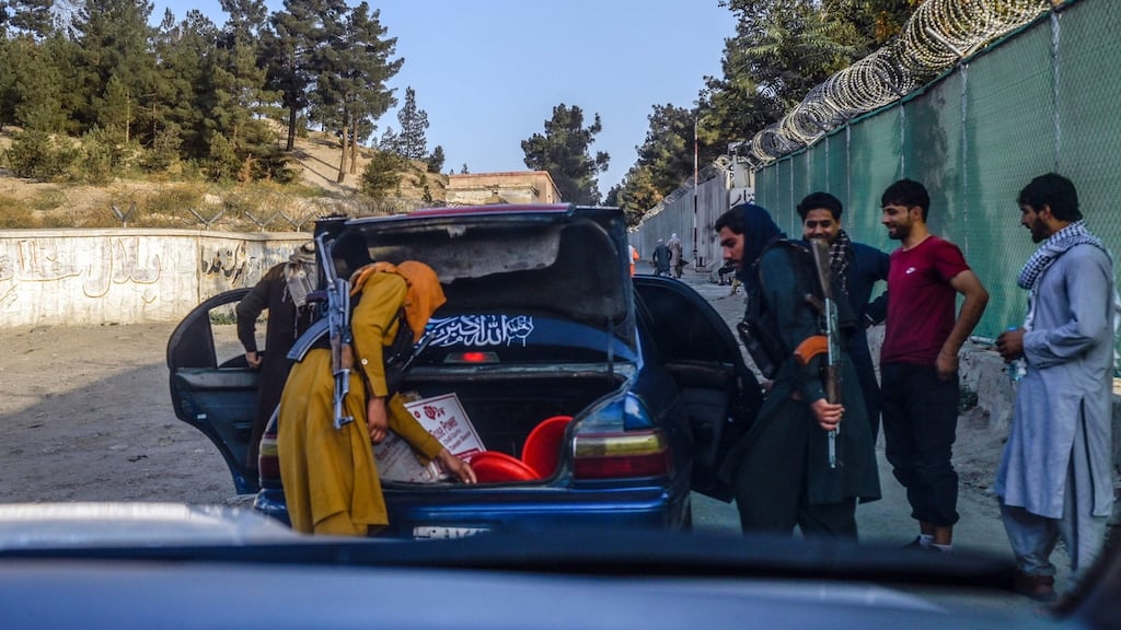 Members of Taliban check a car in Kabul: “I quickly deleted all the messages on my phone, emptied my computer and burnt a few documents because of the fear I had,” says Ali. Photograph: Bulent Kilic/AFP