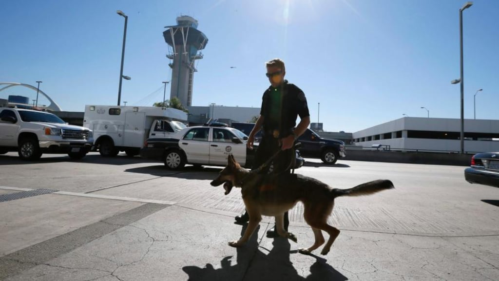 A bomb squad patrols outside terminal 3 after a shooting incident at Los Angeles airport (LAX), California, yesterday. Photograph: Lucy Nicholson/Reuters