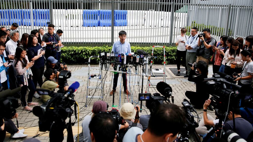 Pro-democracy activist Joshua Wong speaks to journalists after being disqualified from running in local district’s council elections in November, in Hong Kong, China. Photograph: Reuters/Tyrone Siu