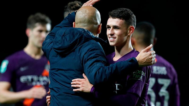 Manchester City’s Catalan manager Pep Guardiola with Phil Foden after his team’s League Cup win. Photograph: Getty Images