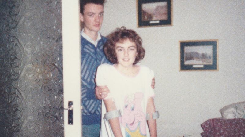 Growing up with arthritis: Sinéad Gleeson on crutches with a hip spica plaster. She was obliged to walk around the house in case of leg clots so her older brother Martin accompanied her.