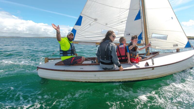 Kevin McCormack on a boat with young sailing students, off Heir Island. Photograph: Michael Mac Sweeney/Provision