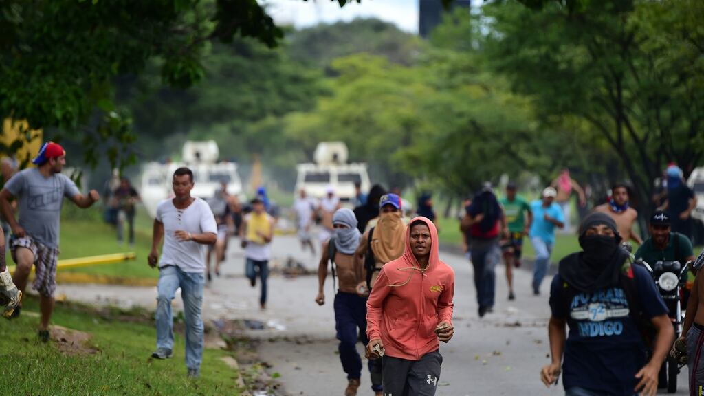 Anti-government activists and the National Guard clash in Valencia city, Venezuela. Photograph: AFP/Getty Images