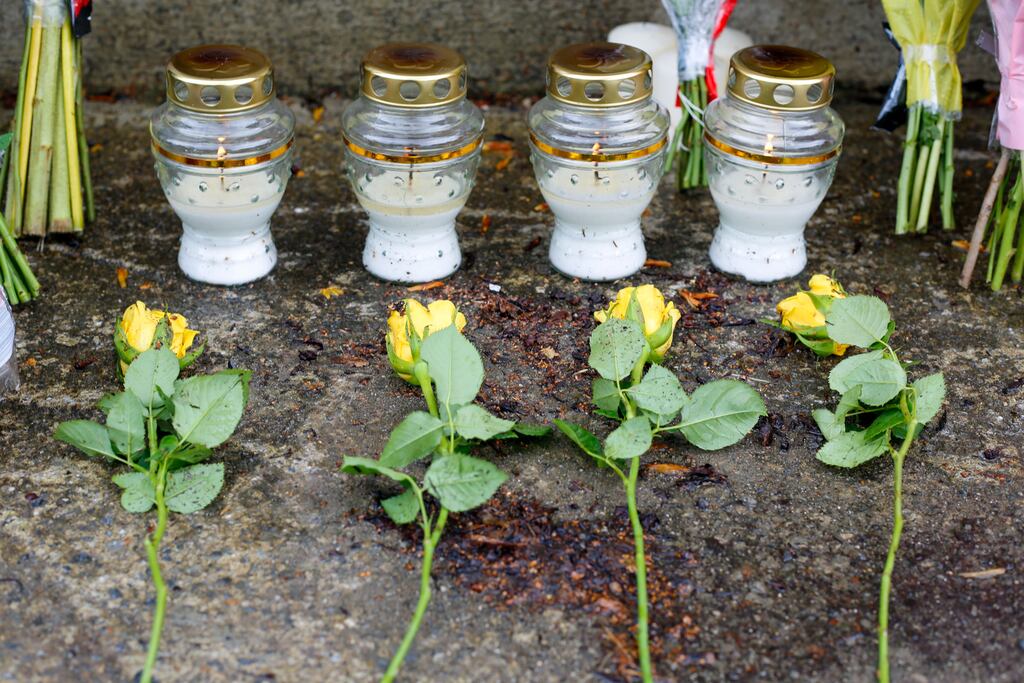 Four individual flowers and candles are seen among tributes left near the scene in Clonmel where four young people died in a car crash on the way to exam results celebrations. Photograph: Damien Storan/PA Wire