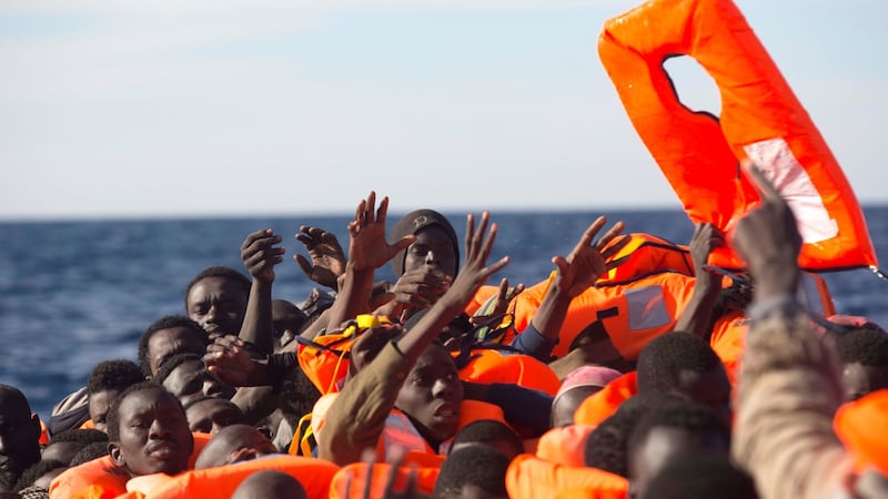Sub-Saharan migrants  reach for a lifevest aboard an overcrowded raft during a rescue operation by the Spanish NGO Proactiva Open Arms in the Mediterranean Sea. Photograph: Giorgos Moutafis/Reuters