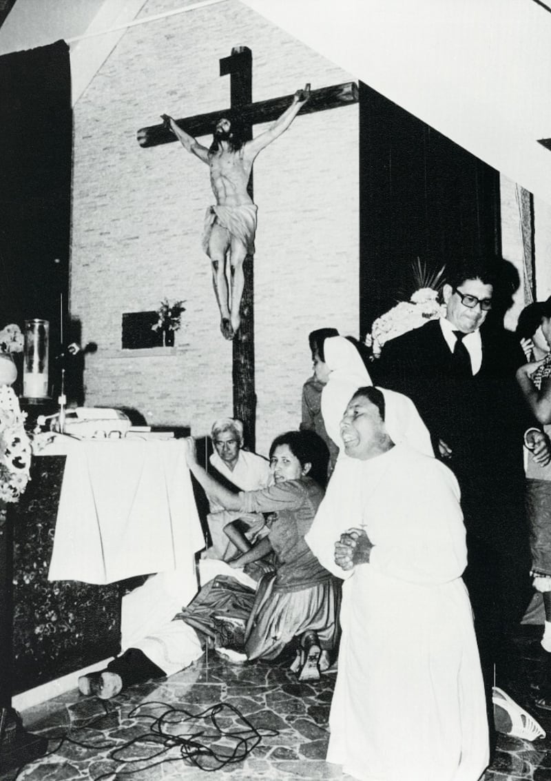 A nun kneels in prayer near the body of Archbishop Oscar Romero shortly after he was assassinated at the Divine Providence Hospital's Chapel on March 24th, 1980 Photograph: Bettmann Archive