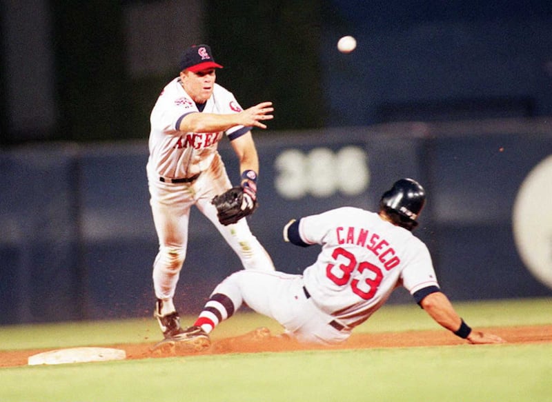Rex Hudler, seen here in action for the California Angels throwing over Jose Canseco of the Boston Red Sox, is most likely the first player who was able to use Mr. Baseball as a resource. Photograph: Frederick M Brown/AFP via Getty Images)