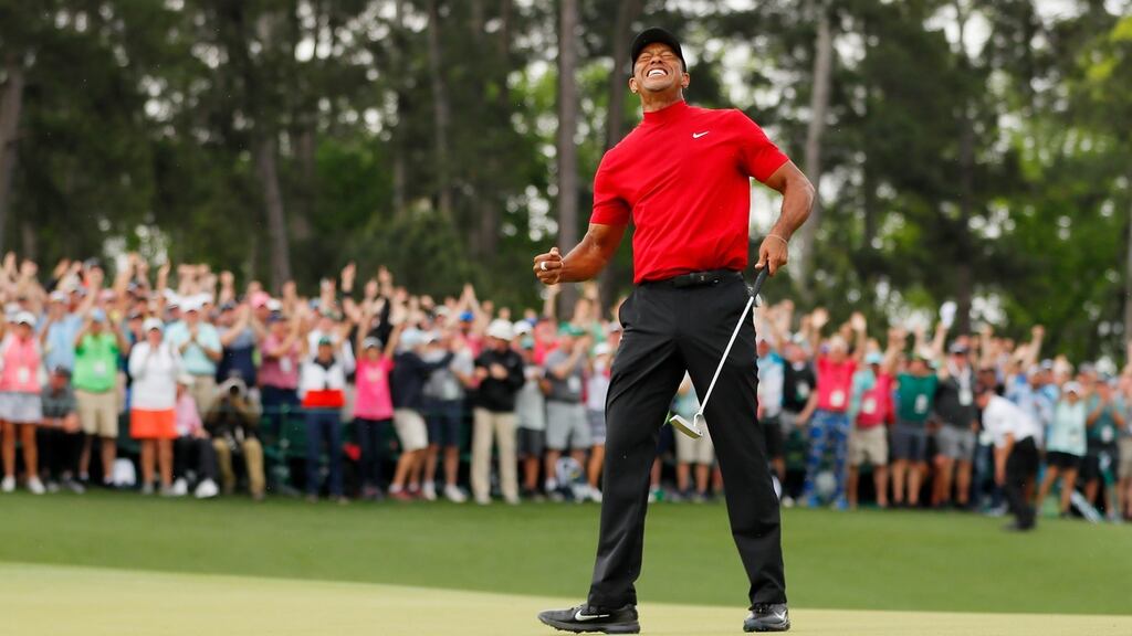 Tiger Woods celebrates after sinking his putt on the 18th green to win the Masters at Augusta. Photograph: Kevin C Cox/Getty