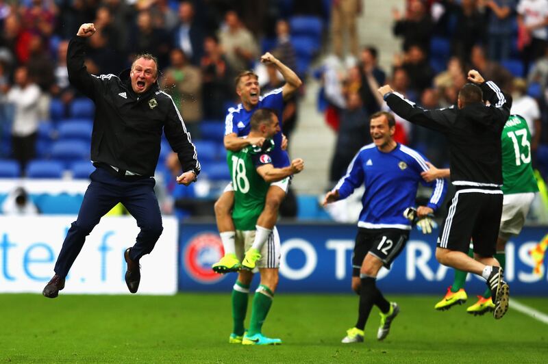 Michael O'Neill, left, celebrates his team's second goal against Ukraine in the Euros in 2016 in Lyon, France. Photograph: Julian Finney/Getty