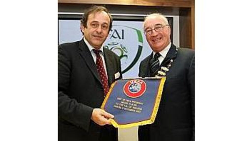 Uefa president Michel Platini makes a presentation to FAI
president David Blood at the unveiling of the association's new
headquarters