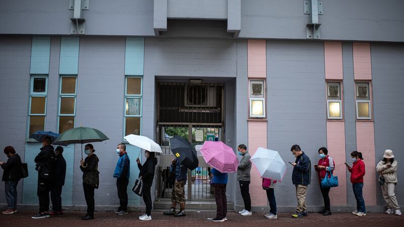 Residents queue at a Covid-19 testing facility in Hong Kong. Photograph: Louise Delmontte/Bloomberg