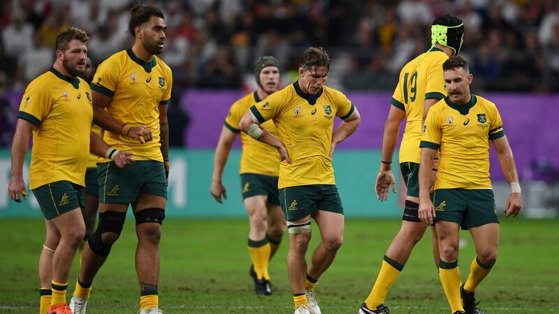 Australia players leave the pitch dejected after their defeat. Photo: Charly Triballeau/Getty Images