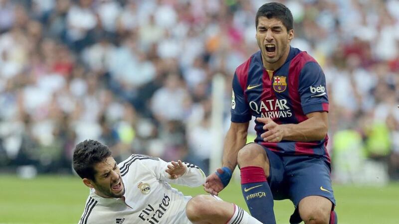 Barcelona’s Luis Suarez is tackled by Real Madrid’s Isco during El Clásico at the Santiago Bernabeu in Madrid. Photograph: JJ Guillen/EPA