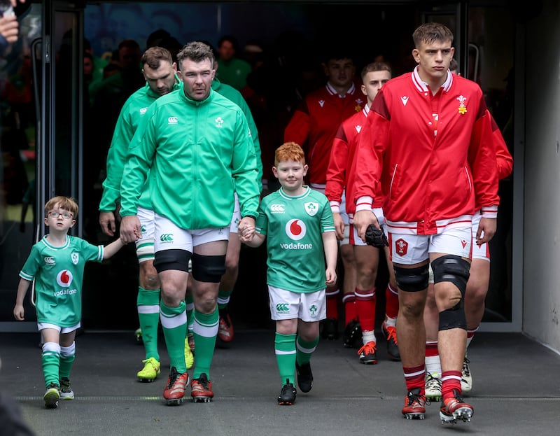 Captains Peter O’Mahony and Dafydd lead their sides out at the Aviva Stadium. Photograph: Dan Sheridan/Inpho