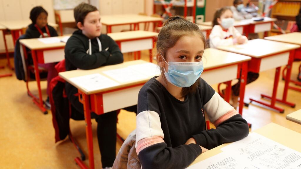 Schoolchildren, some wearing masks, attend a class in a school of Strasbourg, France on Thursday. Photograph:Jean-Francois Badias/AP