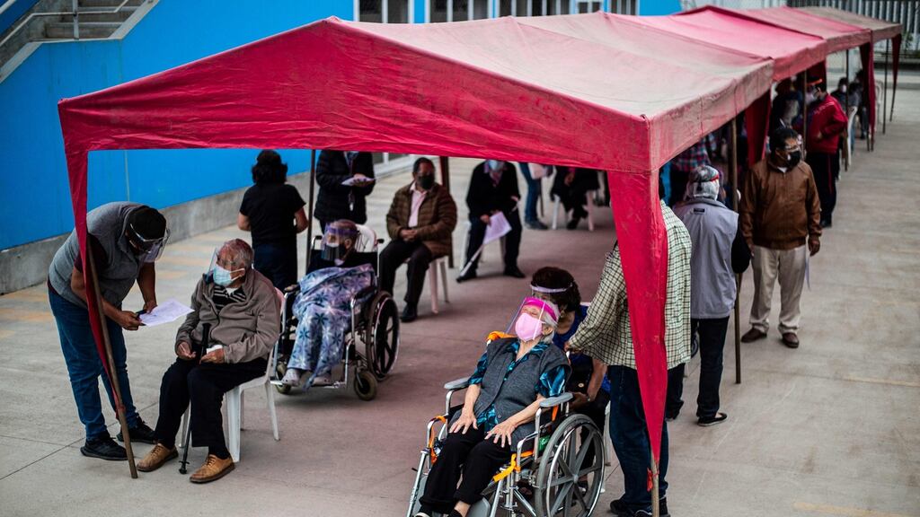 Elderly citizens wait for their turn to get a dose of the Pfizer-BioNTech vaccine at a centre in Lima this week. Photogrph: Getty