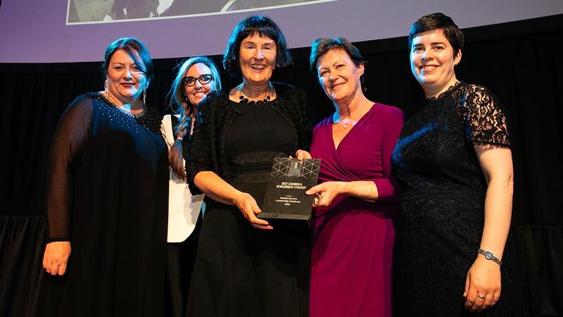 Rose Leonard, Head of Corporate Distribution & Customer Relationships, Zurich Life, presents the Best Learning & Development Strategy award to the HSE Health Service Leadership Academy team.