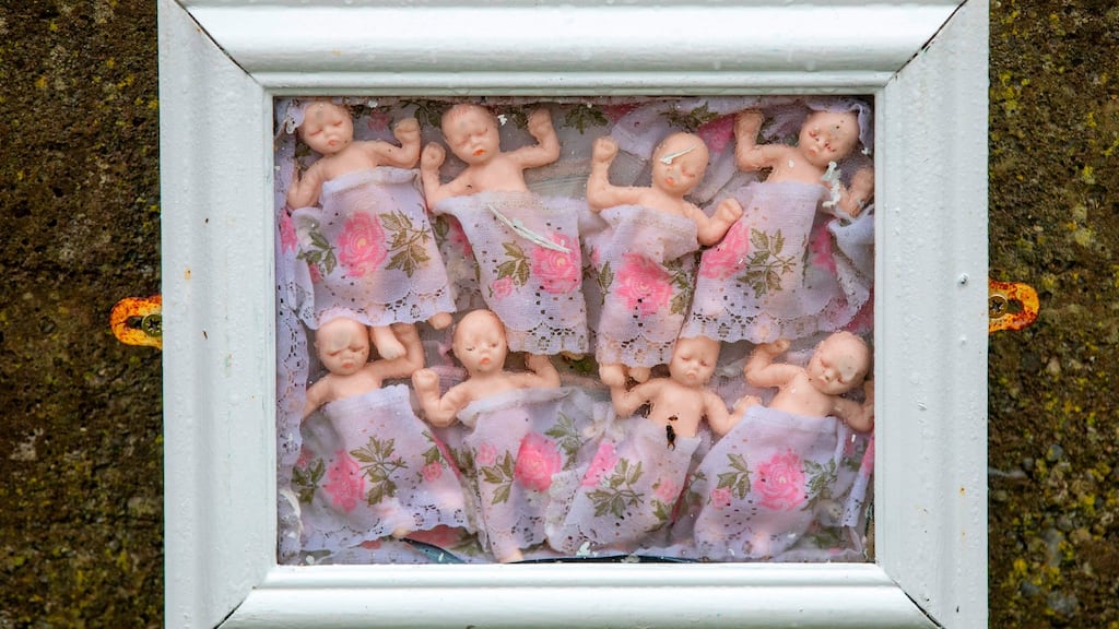 Framed baby dolls pictured at a shrine in Tuam, Co Galway, erected in memory of children buried at the site of the former home for unmarried mothers run by nuns. Photograph: Paul Fait/Getty Images