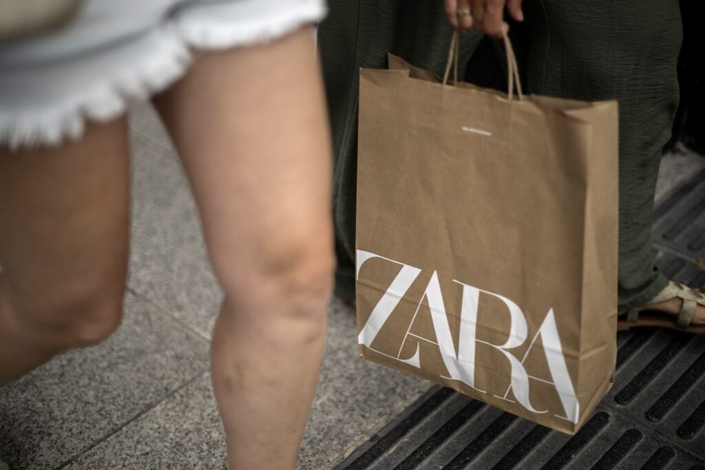 A shopper carries a Zara bag in A Coruna, Spain, on Wednesday, Sept. 6. 2023. Inditex SA’s “unfair” discount and faster revenue growth could spur a further rally in the Zara-owner’s shares over the next 12 months, according to the stock’s newest bull. Photographer: Brais Lorenzo/Bloomberg