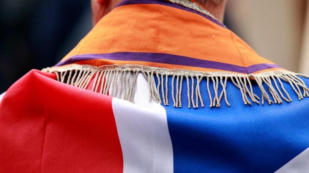A member of the Orange Order wearing a sash and draped in the union flag marches in Belfast. Figures suggest  the order is a weak and declining organisation. Photograph: Reuters