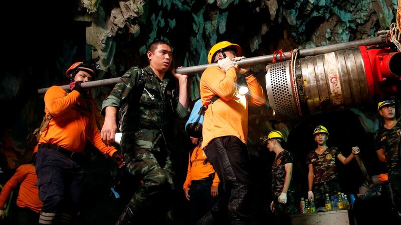 Rescue workers remove equipment from the cave. Photograph: Soe Zeya Tun/Reuters
