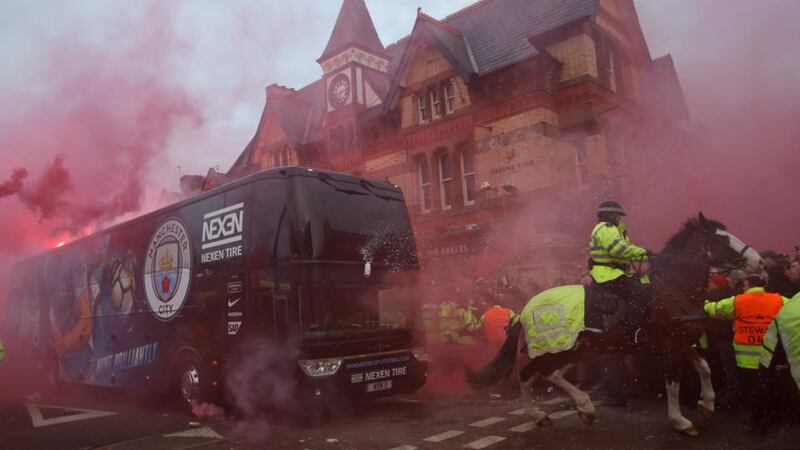 Liverpool fans throw missiles as Manchester City’s team coach ahead of their Champions League quarter-final at Anfield. Photograph: Carl Recine/Reuters