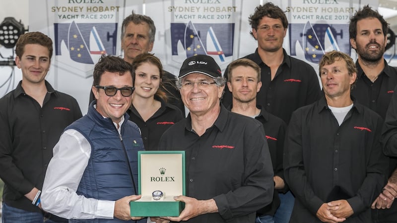 Jim Cooney, centre, owner of Australian super-maxi yacht Comanche, celebrates victory in the Sydney to Hobart yacht race with his crew. Photograph: Luca Butto/AFP/Getty Images