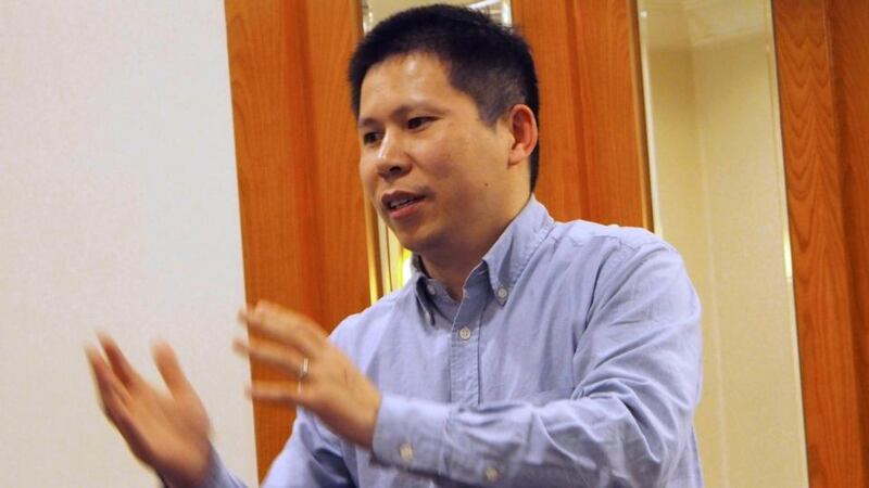 Chinese rights advocate Xu Zhiyong speaks during a meeting in Beijing in this file handout photo dated March 30th, 2013. A Chinese court sentenced Xu, one of China’s most prominent rights advocates, to four years in prison after he campaigned for the rights of children from rural areas to be educated in cities and for officials to disclose their assets. Photograph: Xiao Guozhen/Handout via Reuters/Files