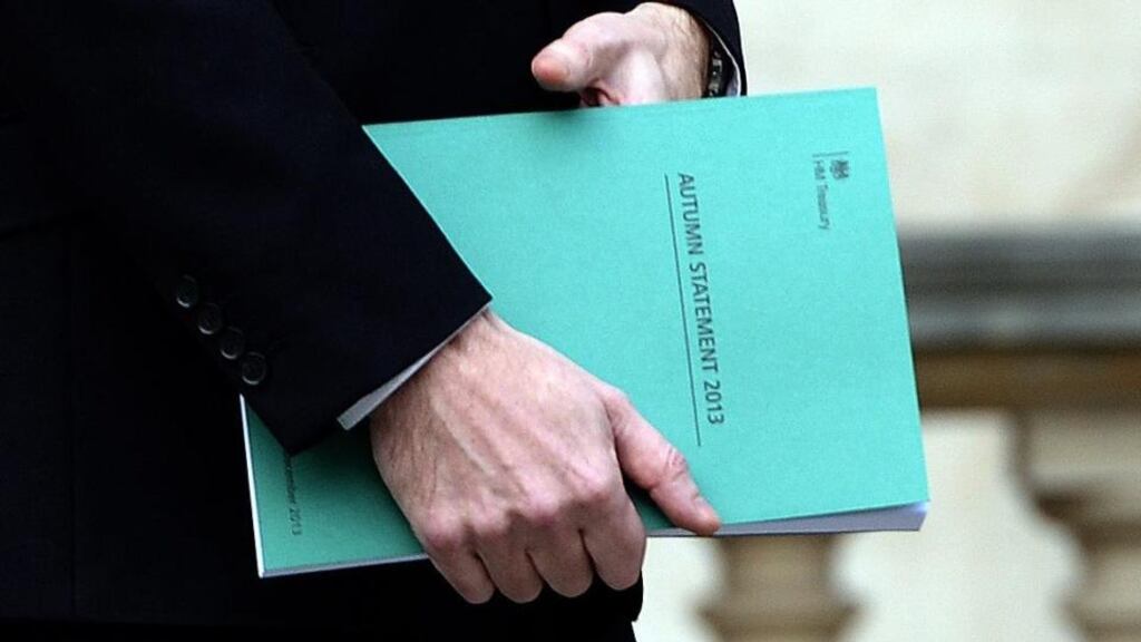 British chancellor of the exchequer, George Osborne with a copy of the 2013 autumn statement yesterday.