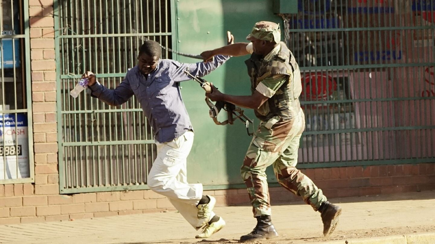 A Zimbabwean soldier beats a man on a street in Harare on Wednesday. Photograph: Zinyange Auntony/AFP/Getty Images
