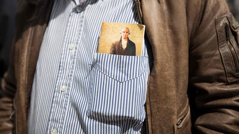 A protester holds a copy of the constitution in his pocket at a rally at the Ohio State House in Columbus, Ohio. Photograph: Megan Jelinger/AFP via Getty