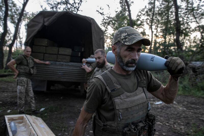 Soldiers of the 22nd Mechanized Brigade unload ammunition from a truck for a 2S1 Gvozdika 122mm self-propelled howitzer in the Bakhmut area of Ukraine. Photograph: Tyler Hicks/The New York Times