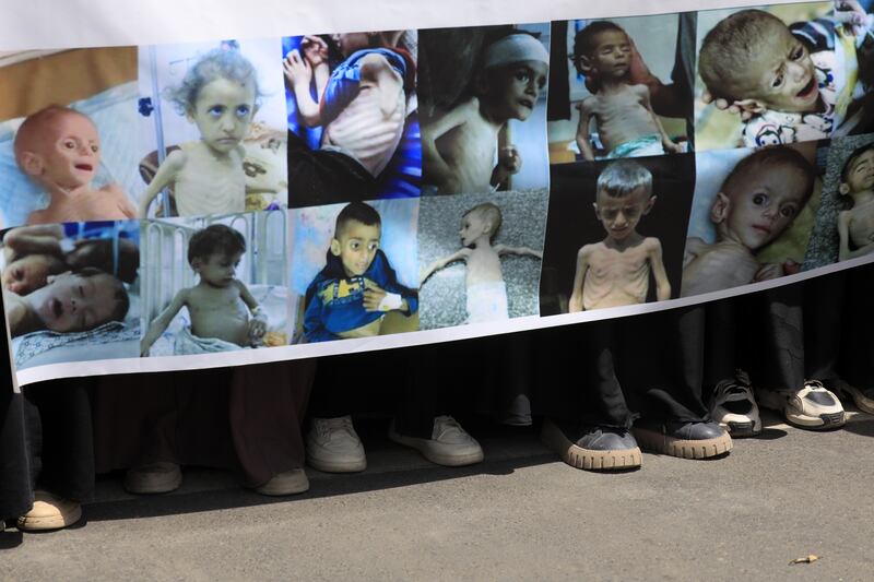 Protesters hold a banner showing starving Palestinian children during a rally in solidarity with the Palestinian people, at Sana'a University in Yemen. Photograph: Yahya Arhab/EPA