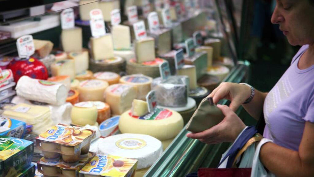 A woman shops for cheeses at a market in Bilbao. Spain’s consumer prices rose in June, the first time in around a year. Photograph: Markel Redondo/Bloomberg News.