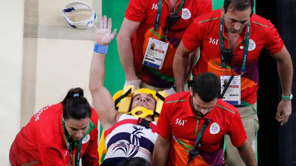 France’s Samir Ait Said waves to the crowd as he is stretchered off after breaking his leg while competing in the qualifying for the men’s vault at the Olympic Arena. Photograph: Thomas Coex/AFP/Getty Images