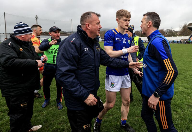 Wicklow manager Oisín McConville has words with a member of the Carlow backroom team after the game. Photograph: Dan Sheridan/Inpho