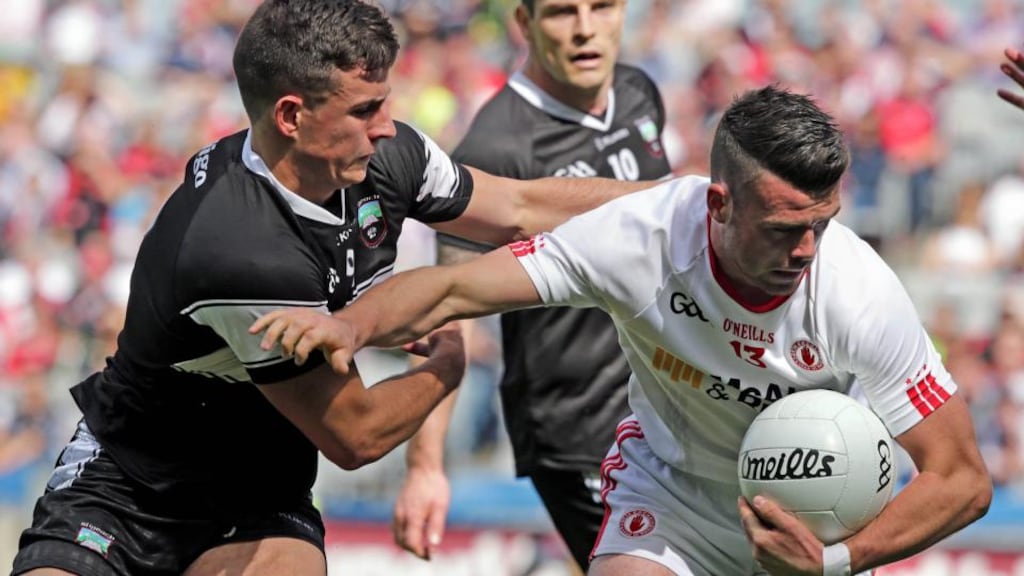 Darren McCurry tries to shrug off the attentions of Sligo’s Niall Murphy as Tyrone booked their place in the quarter-finals of the All-Ireland championship. Photograph: Morgan Treacy/Inpho