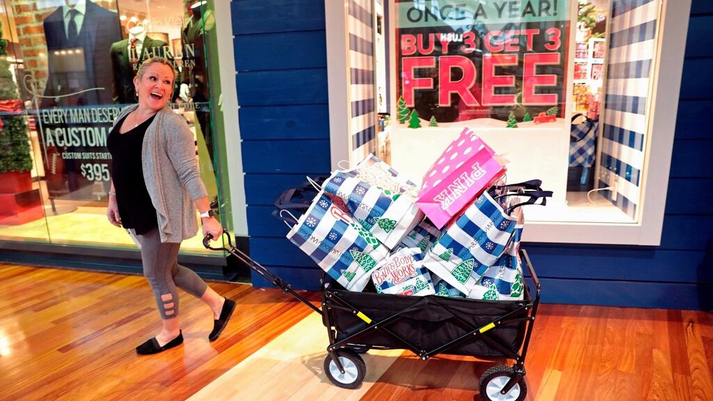 In US retail stocks dipped on signs of a tepid start to in-store Black Friday sale. Mona Spiker hauls away her purchases during Black Friday in Missouri. Photograph: Cristina M Fletes/St Louis Post-Dispatch via AP