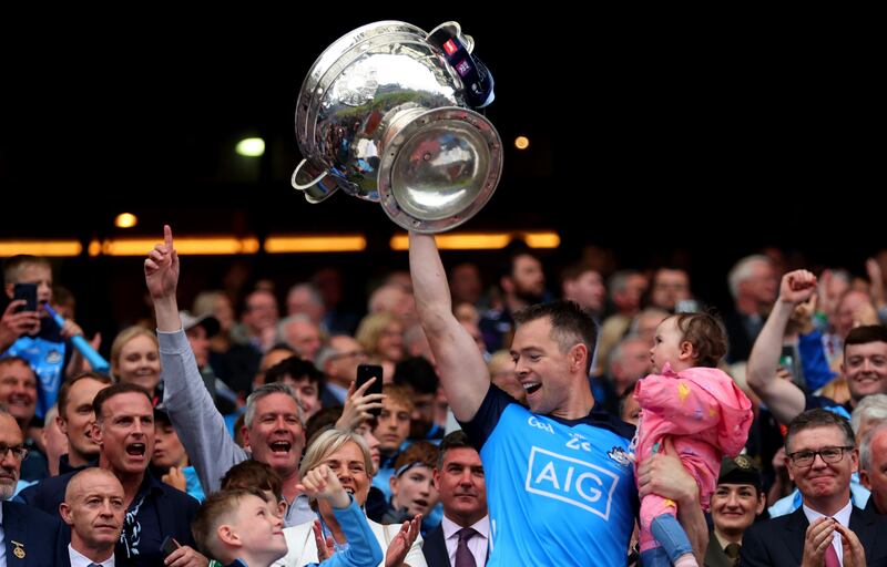 Dean Rock holds Sam Maguire and daughter Sadie following victory over Kerry. Photograph: James Crombie/Inpho