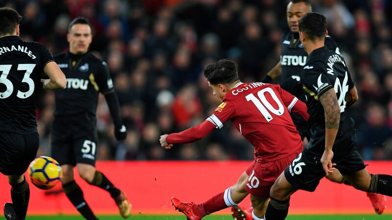 Coutinho curls in the opener. Photograph: Getty Images