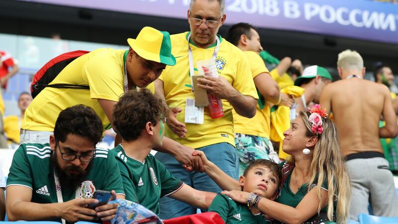Brazil fans console Mexico fans after their 2-0 last-16 victory in Samara. Photograph: Ryan Pierse/Getty