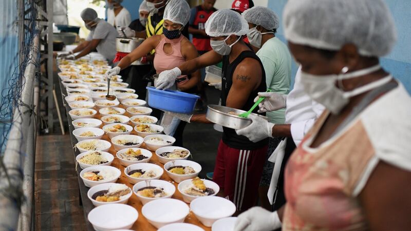 A group of residents of the Chapeu Mangueira slum, prepares food to distribute it to homeless people in Copacabana during the coronavirus outbreak, in Rio de Janeiro, Brazil. Photograph: Reuters/Lucas Landau